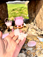 Load image into Gallery viewer, hand holding Apophyllite Crystal with pink cauldron in the background
